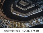 Curve metal roof and stair of observation deck in the forest, the modern design roof with blue big tree and blue sky background. Copy space.