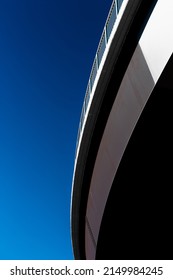 Curve Of A Pedestrian Bridge Overhead  Against Graduated Blue Sky