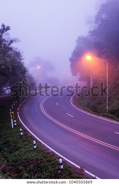 Curve road with fog,\
Thailand.