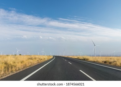 Curve Road Motion Blur Through The Wind Farm Against A Blue Sky, Qinghai Province, China