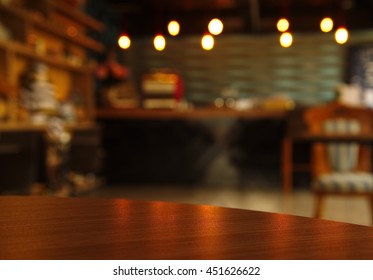 Curve  Wood Table Surface With Blur Bar Or Cafe Scene At Night 