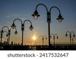 Curved artistic lampposts in Liberty State Park in Jersey City New Jersey at sunrise