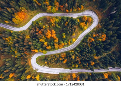 Curved Bending Road In The Forest. Aerial Image Of A Road. Forrest Pattern. Scenic Curvy Road Seen From A Drone In Autumn. Aerial Top Down View Of Zig Zag Winding Mountain Road, Drone Shot.