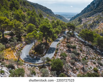 Curved Bending Road In The Forest. Aerial Image Of A Road. Forrest Pattern. Aerial Top Down View Of Zig Zag Winding Mountain Road, Drone Shot.