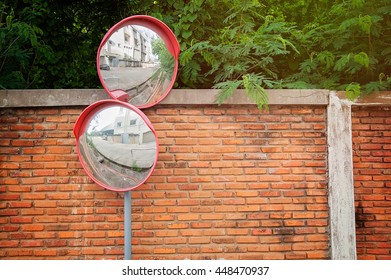 Curved Corner Traffic Mirror On The Roadside. 