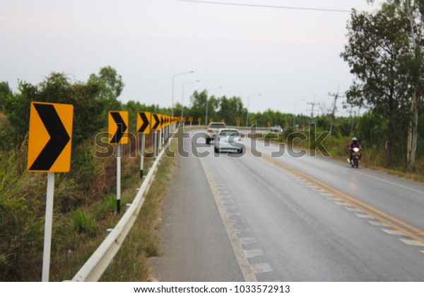 Curved hazard\
and sign warning curve.(Photo\
blur)
