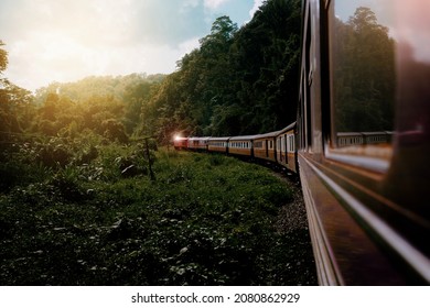 Curved Passenger Train ,train on the railway in a high mountain forest with tall trees in the summer landscape. - Powered by Shutterstock