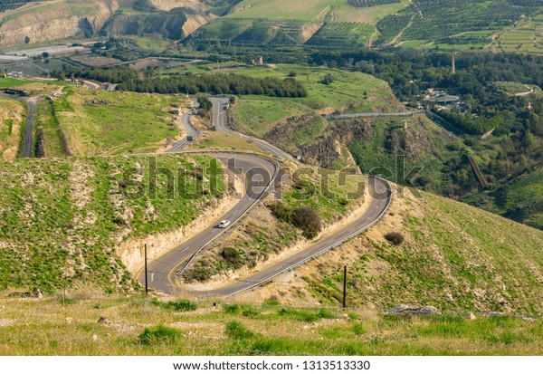 curved road on the\
mountain with blue sky.