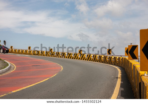 a curved road and\
signboard