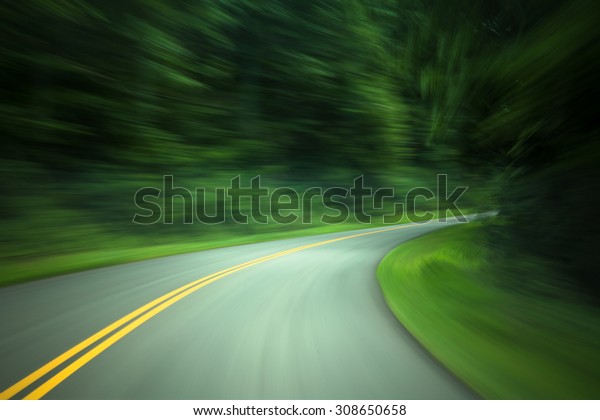 Curved road\
through country road with motion\
blur