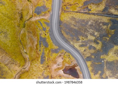 Curved road through scenic lava fields in Iceland