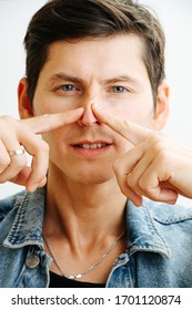 The Curved Septum Of The Nose. Portrait Of A Young Man Shifting The Nose To The Side Returning The Aesthetic Look Of The Nose