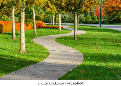 Curved Sidewalk, Path, Trail At The Empty Street. Neighborhood Scenery.