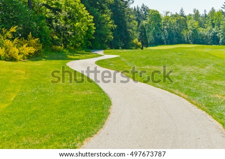 Curved sidewalk, path, trail at the empty street. Neighborhood scenery.