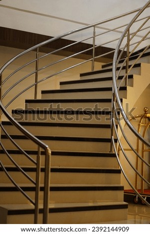 The curved staircase stands firmly in the middle of the room

