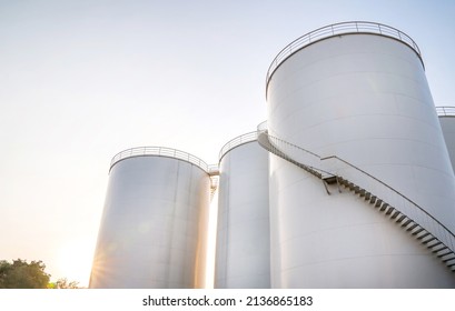 Curved Stairway Of Base Oil Storage Tank In The Petroleum Factory With Blue Sky. Industrial Petroleum Plant. Base Oil For Automotive Engine Oil And Industrial Oil Application.