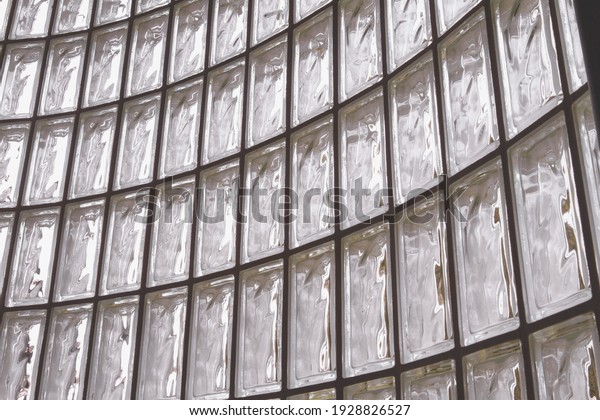Curved wall of glass blocks; abstract design of\
light through glass block\
window