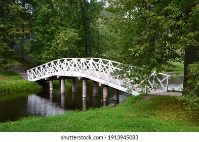 Curved White Bridge In The Park