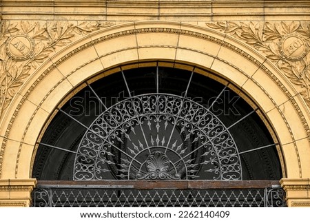 curved window with ornate metal design