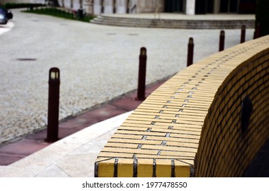 curved yellow brick wall closeup detail with parapet wall. soft blurred background. selective focus. brick pattern and texture. architecture and landscape soft background. abstarct view.