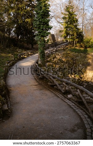 Curving Park Path with Rustic Railings and Stone Walls