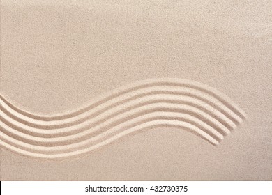 Curving Wave Pattern Raked Into Smooth Manicured Sand In A Japanese Zen Garden For Meditation And Tranquility With Copy Space Above