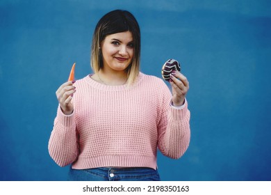 Curvy Girl Comparison Between A Carrot And A Donut - Hungry Chubby Woman Indecision Between Healthy Or Junk Food - Humor And Diet Body Positive Lifestyle