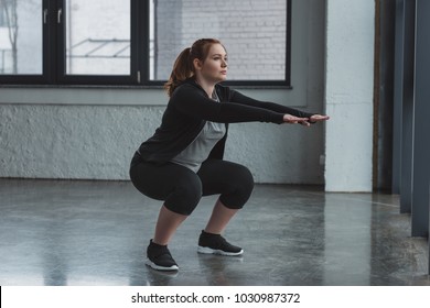 Curvy Girl Doing Squat In Gym