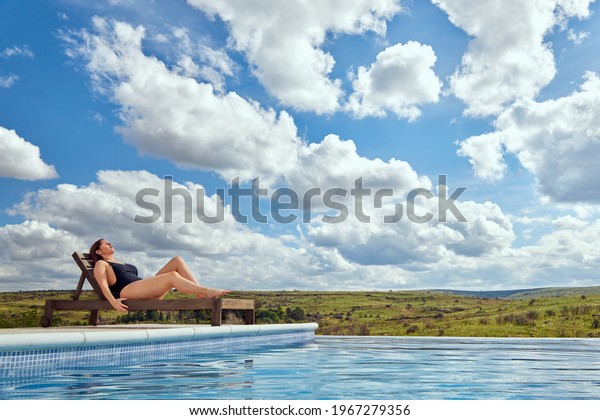 Curvy Latina Woman Sunbathing On Wooden Stock Photo Edit Now