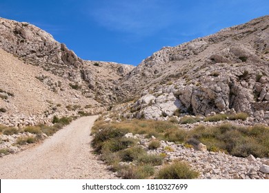 Curvy Mountain Road In A White Limestone Valley.