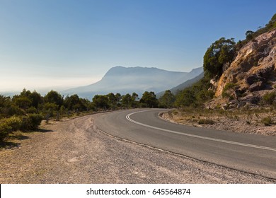 Curvy Olivers Road At The Curve With Misty View Of Southern Side Of Mt Roland In Background. Taken From  Round Mt Claude Lookout In Tasmania, Australia
