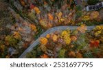 Curvy road in the fall foliage forest of East Stroudsburg, Pennsylvania. 