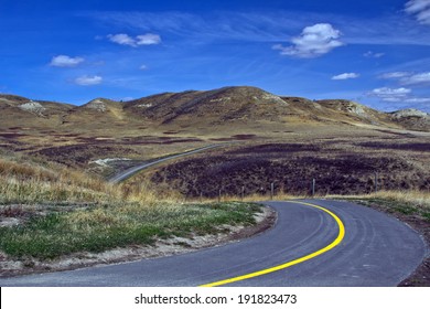 A curvy road through ranches in Alberta, Canada