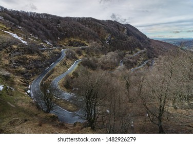 Curvy And Sloppy Road In The Mountains With Snow. Urbasa In A Cloudy Day.