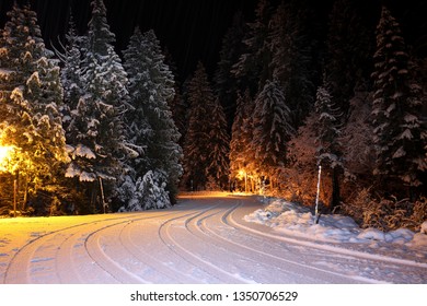 Curvy And Snowy Night Time Road.