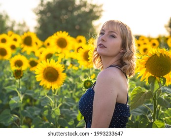 A Curvy Spanish Woman Posing In The Sunflower Field