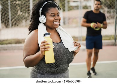 Curvy woman doing workout morning routine outdoor at city park - Focus on face - Powered by Shutterstock