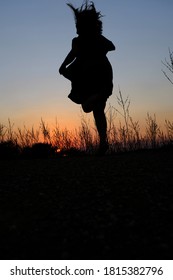 Curvy Woman Running Silhouette At Sunset