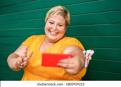 Curvy Woman Taking Selfie With Mobile Phone Outdoor - Coronavirus Lifestyle And Technology Trends Concept - Focus On Face