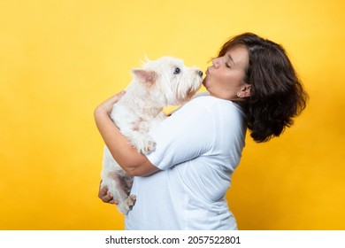 Curvy Young Woman With Her Dog On Yellow Background