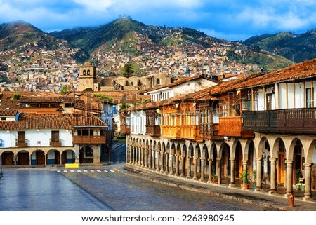 Cusco Old town, Peru, view of the traditional colonial style houses with balconies and archways on the main square Plaza de Armas, St Francis church and surrounding Andes mountains