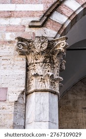 Cusped Gothic mullioned windows (trifore) with a griffin bas-relief, heraldic symbol of Perugia, on the facade of Palazzo dei Priori facing Piazza IV Novembre, seat of the Galleria Nazionale dell'Umbria, in Perugia, Italy.