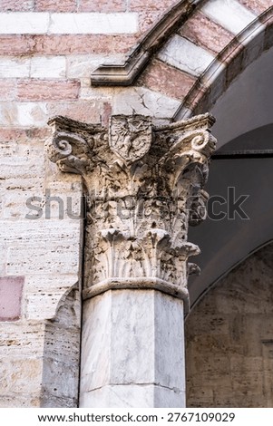 Cusped Gothic mullioned windows (trifore) with a griffin bas-relief, heraldic symbol of Perugia, on the facade of Palazzo dei Priori facing Piazza IV Novembre, seat of the Galleria Nazionale dell'Umbria, in Perugia, Italy.