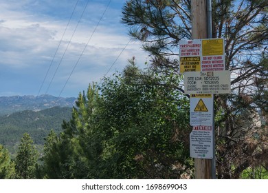 Custer, SD, USA, 2019-07-15: Warning Signs On Pole On Mount Coolidge