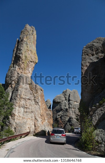 CUSTER STATE PARK, SOUTH DAKOTA\
- June 9, 2014:  Cars driving on the Needles Highway next to tall\
quartz rock formations in Custer State Park, SD on June 9,\
2014.