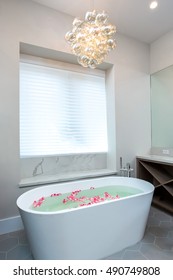 Custom Bathroom With Deep Soaking Tub And Chandelier 