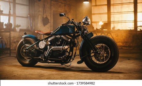 Custom Bobber Motorbike Standing in an Authentic Creative Workshop. Vintage Style Motorcycle Under Warm Lamp Light in a Garage. - Shutterstock ID 1739584982