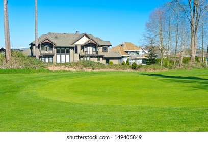 Custom built big luxury house with nicely trimmed front yard, lawn in front of the golf course in a residential neighborhood. Vancouver Canada. - Powered by Shutterstock