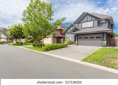 Custom Built Luxury Homes With Nicely Trimmed And Designed Front Yard, Lawn In A Residential Neighbourhood In Canada. Street Of Houses.