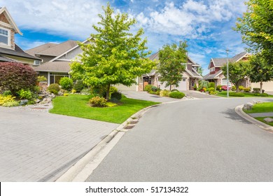 Custom Built Luxury Homes With Nicely Trimmed And Designed Front Yard, Lawn In A Residential Neighbourhood In Canada. Street Of Houses.